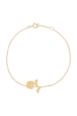 Gold bracelet with a rose charm on a white background