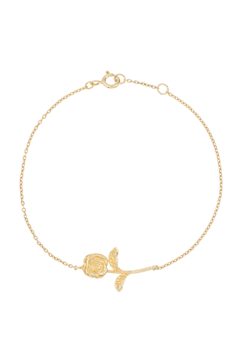Gold bracelet with a rose charm on a white background