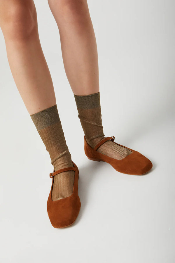 Brown ballet flats and socks on a white background