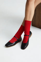 Red socks with black shoes on a white background