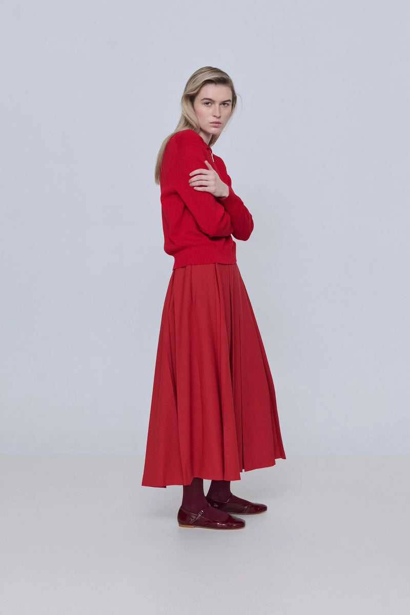 Woman wearing a red outfit on a white background