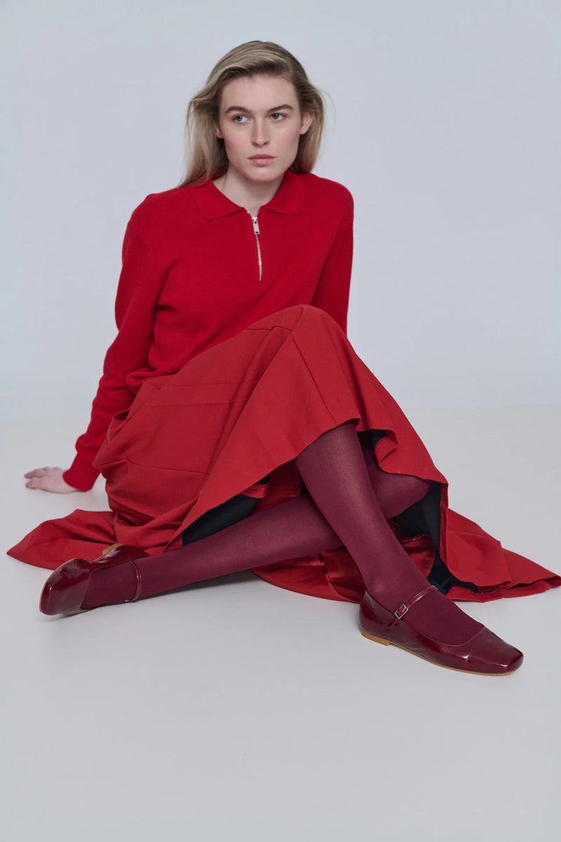 Woman wearing a red dress and shoes on a white background