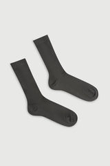 Pair of black socks on a light gray background
