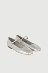 Pair of silver ballet flats on a light gray background