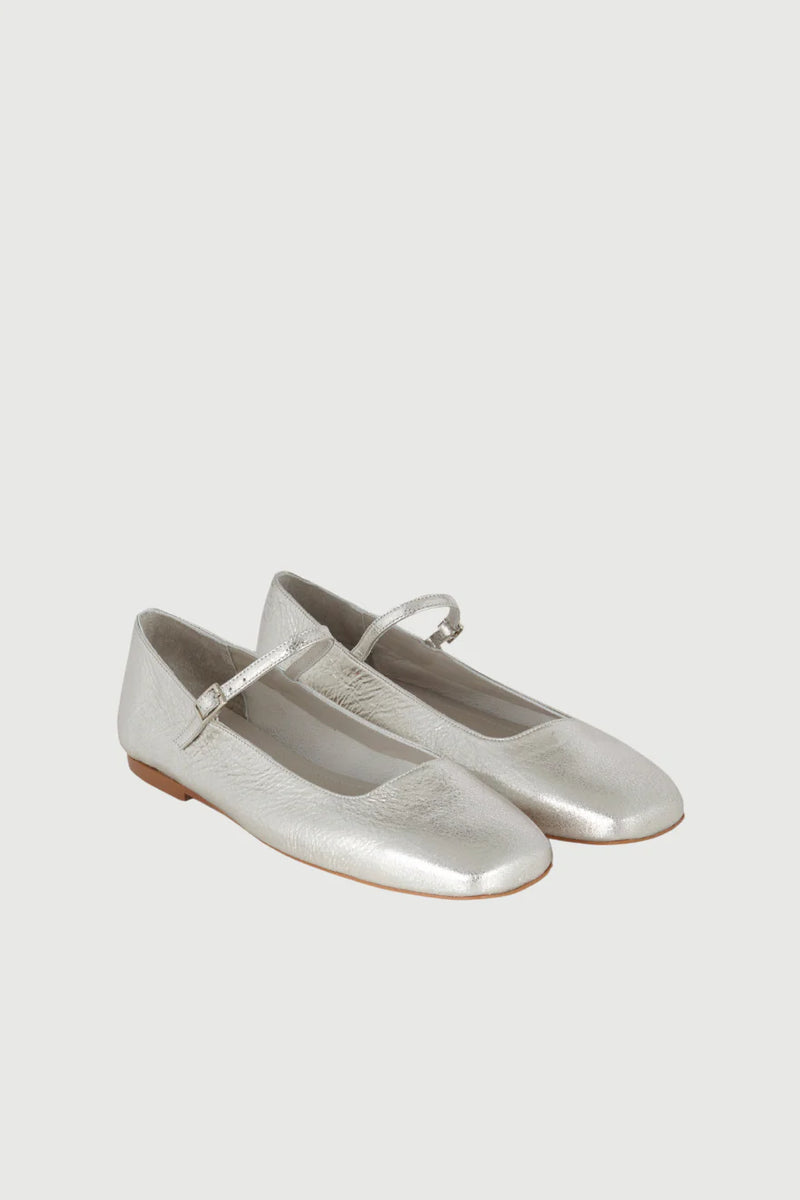 Pair of silver ballet flats on a light gray background