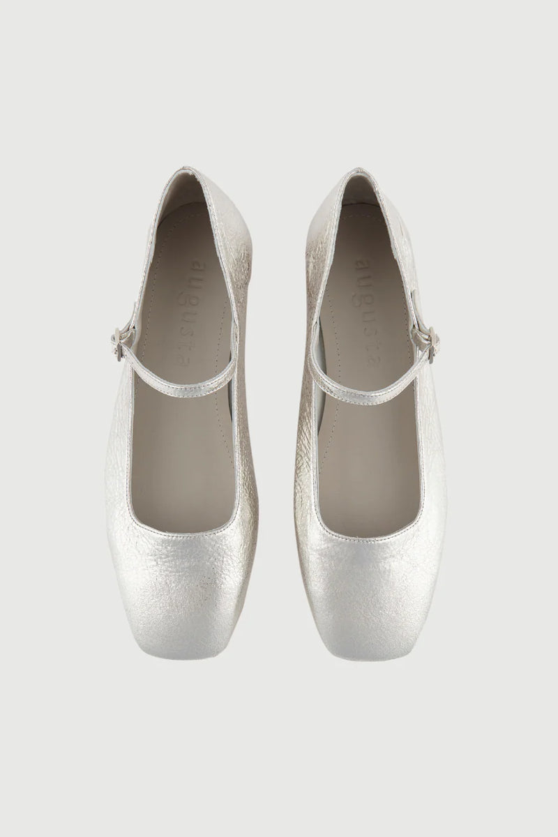 Pair of silver high heels on a light gray background