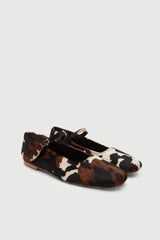 Pair of cowhide leather shoes on a light gray background