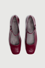 Pair of maroon shoes with 'August' branding on a white background