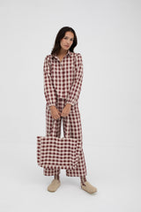 Woman wearing a red and white checkered outfit on a white background