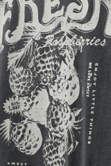 Black and white label with raspberries and text on a dark background