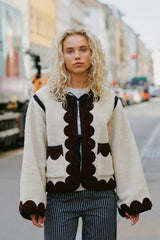 Woman wearing a patterned cardigan on a city street