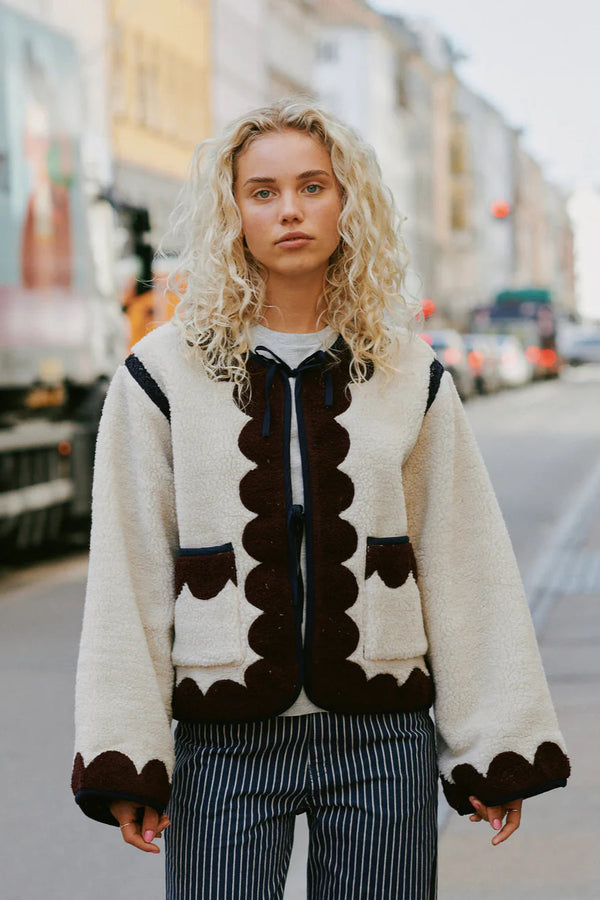 Woman wearing a patterned cardigan on a city street