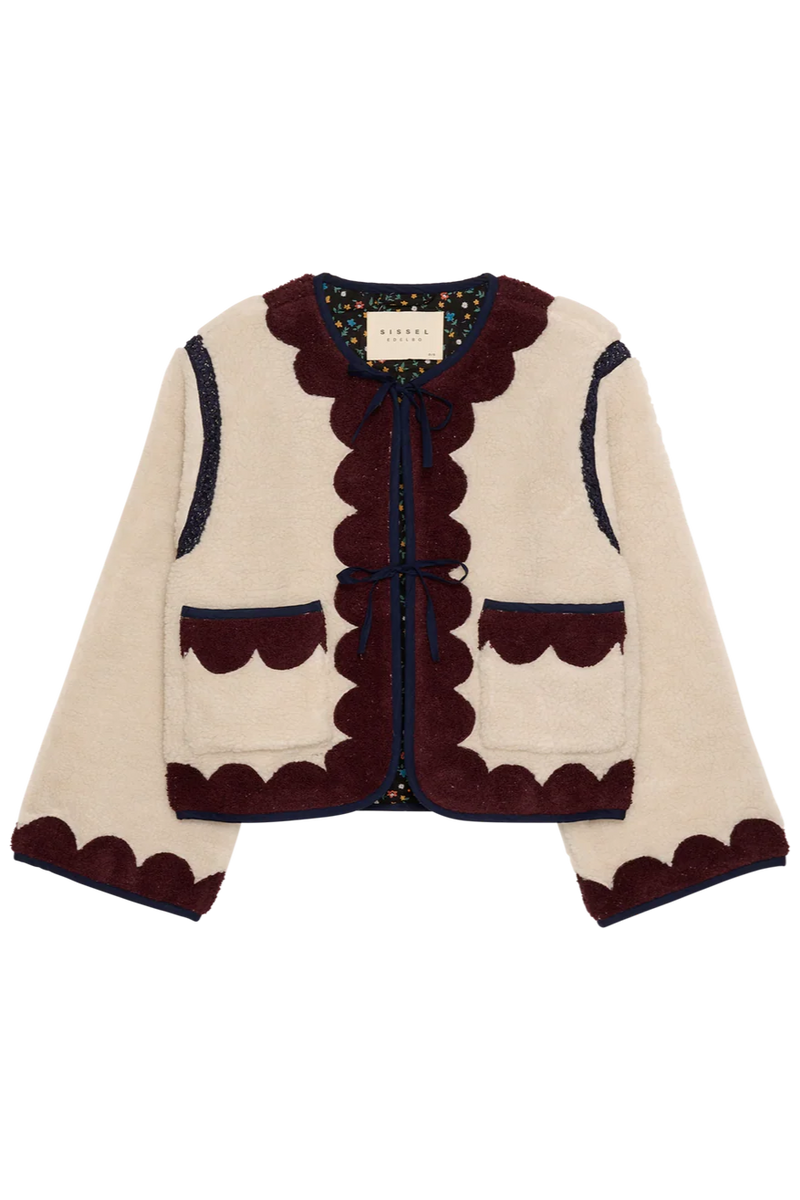 Knitted cardigan with scalloped edges on a white background