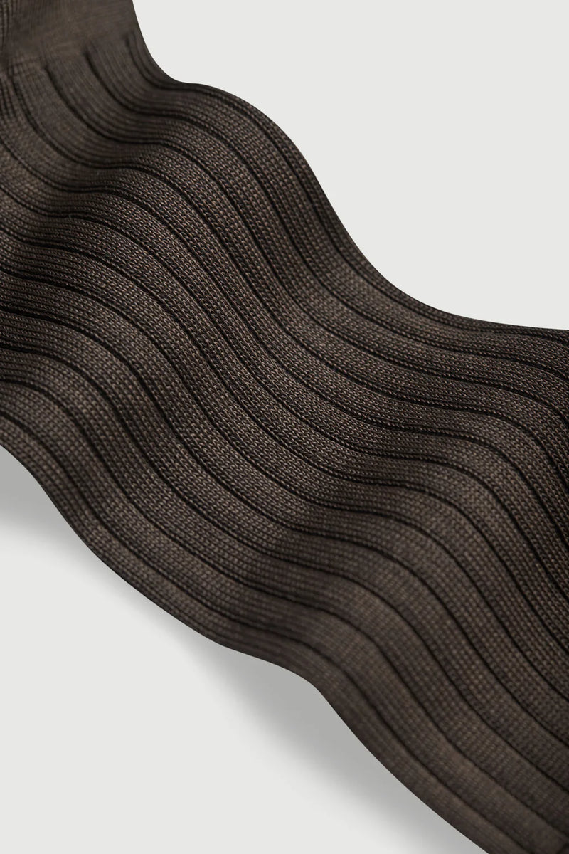 Close-up of brown textured fabric on a light gray background