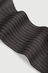 Close-up of black ribbed socks on a light gray background