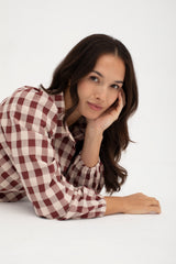 Woman wearing a checkered shirt on a white background